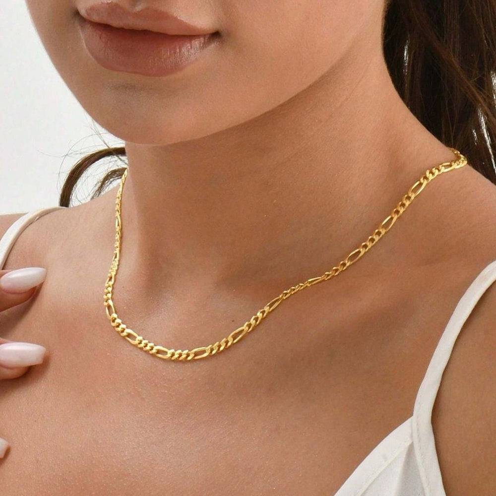 Woman wearing gold personalized fashion necklace Figaro style, ethical affordable jewelry made from stainless steel and titanium.