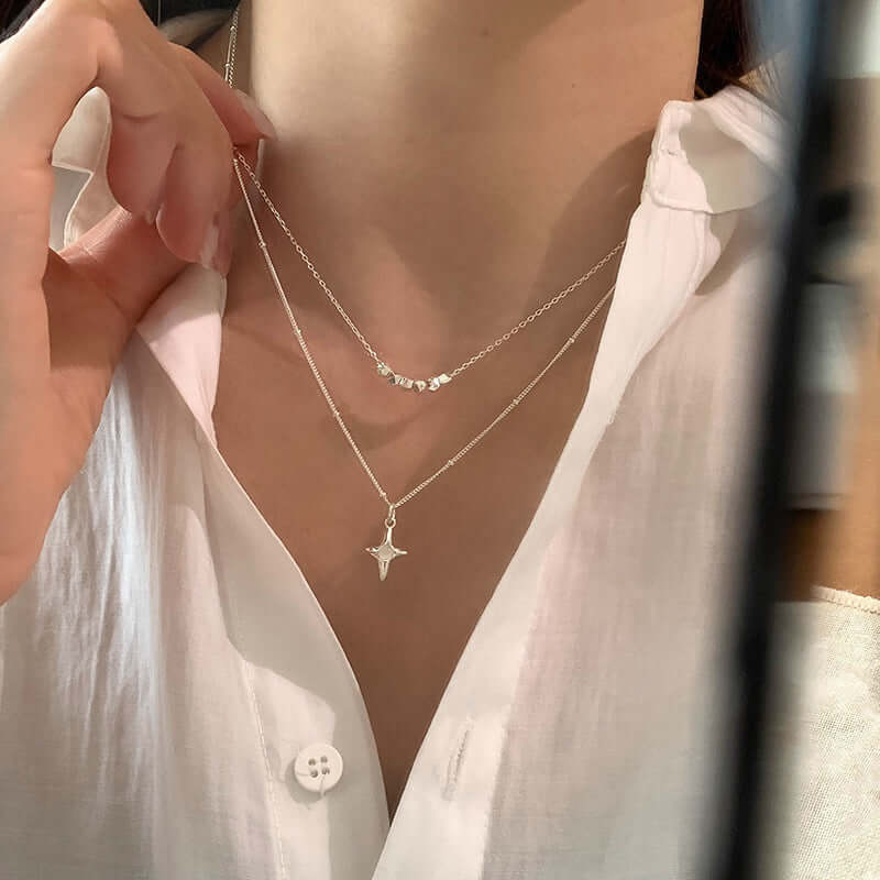 Woman wearing double-layer opal cross necklace, featuring a stylish geometric design, trendy and sexy jewelry in copper material.